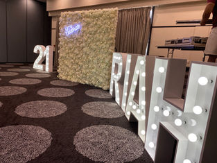 21 RIAH giant light up letters and numbers with our luxe white flower wall and 'Let's Celebrate' neon sign set to white at Fitzy's Loganholme Brisbane