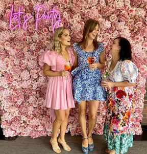 Bella pink flower wall with 'Let's Party' neon sign at Blackbird Brisbane