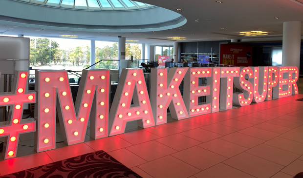 Corporate slogan hashtag light up letters at automotive conference and racing event brand activation