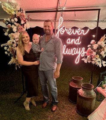 Forever and always neon sign with black frame stand and mocha and white rose flower garland