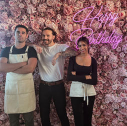 Bella pink flower wall with 'Happy Birthday' neon sign