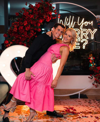 Will you Marry Me? neon sign with white circular mesh stand, red rose florals and giant light up love heart at W Hotel Brisbane