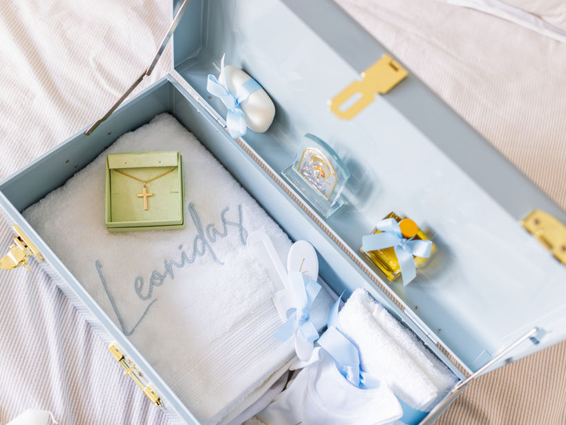 Blue christening keepsake box with embroidered details and baptism accessories