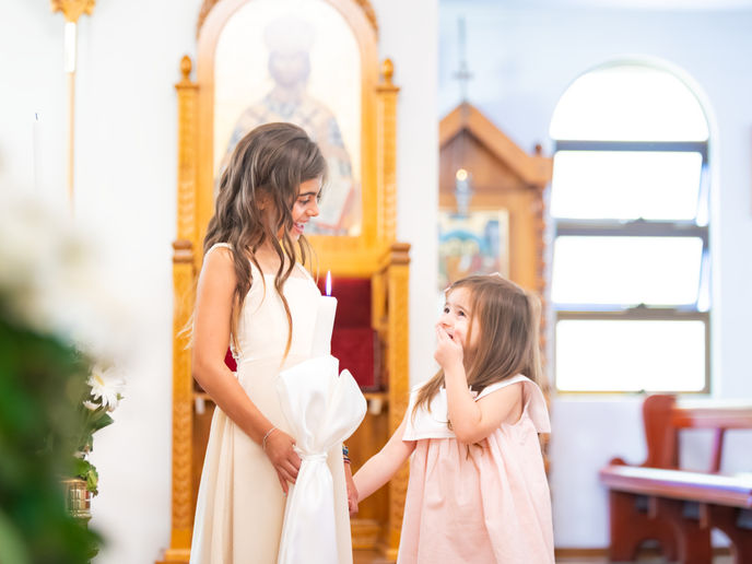andlelit interior of Sydney church during baby baptism ceremony