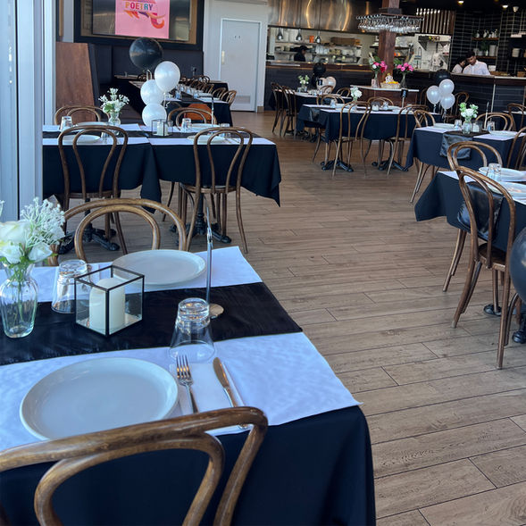 Spacious dining area at Poetry – The Beauty of Indian Flavours with elegantly set tables, modern décor, and a welcoming restaurant interior in Adelaide