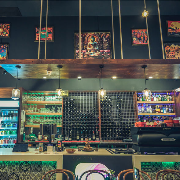 Stylish bar interior at Poetry – The Beauty of Indian Flavours featuring wine displays, ambient lighting, and modern Indian-inspired décor in Adelaide