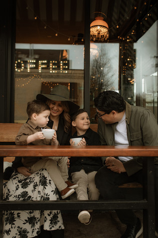 family talks while sitting outside a portland coffee shop