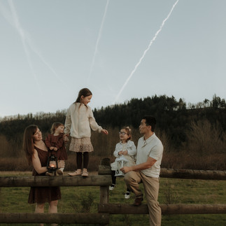 portland family photographer captures family standing on fence