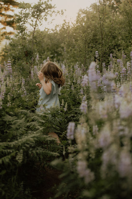 girl runs through field of flowers in the Columbia river gorge