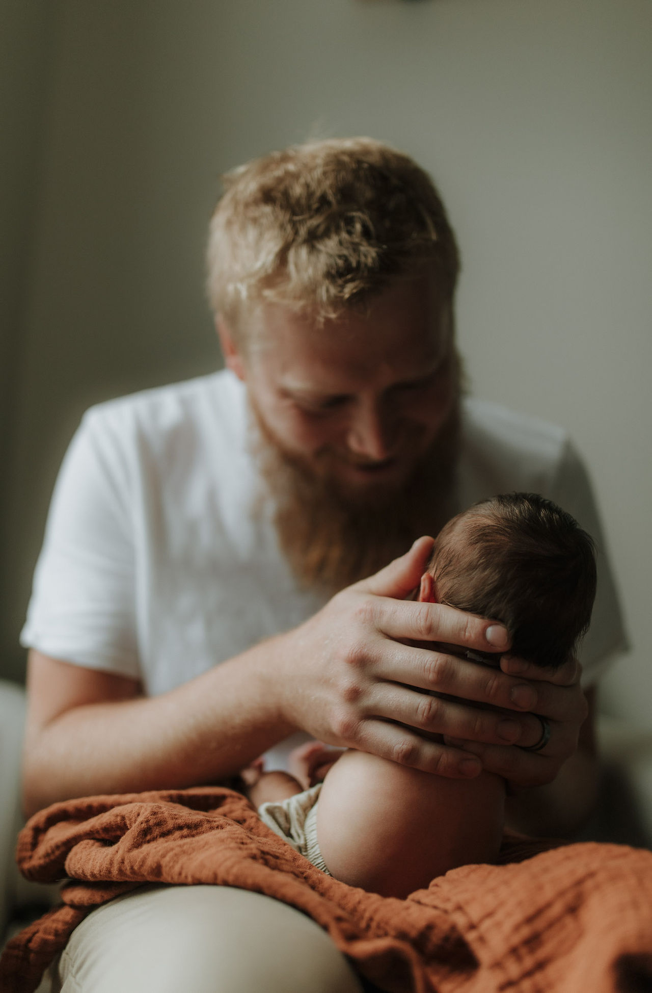 a father burps his baby