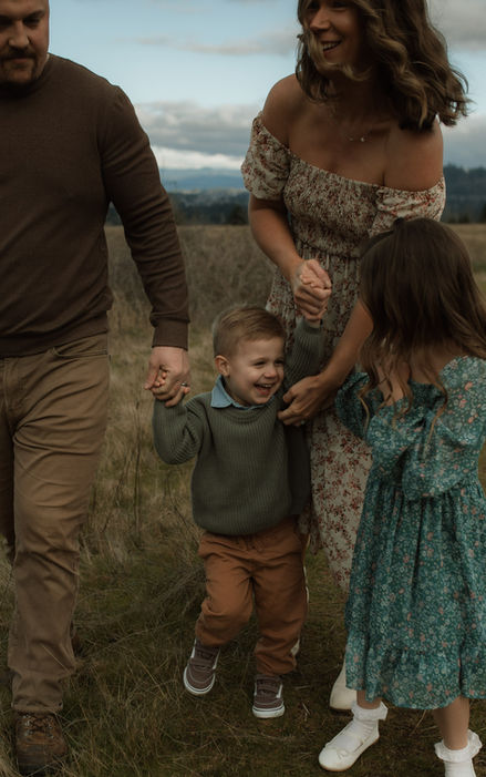 family of four walk on hillside of Powell Butte Nature Park