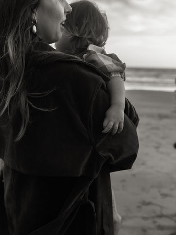 a mother holds her baby on the oregon coast
