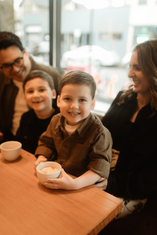 boy smiles with whipped cream mustache