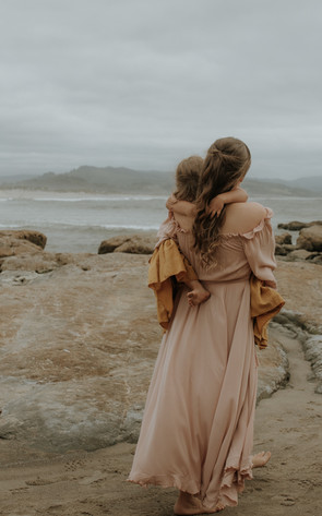 family walks out on rocks on the oregon coast