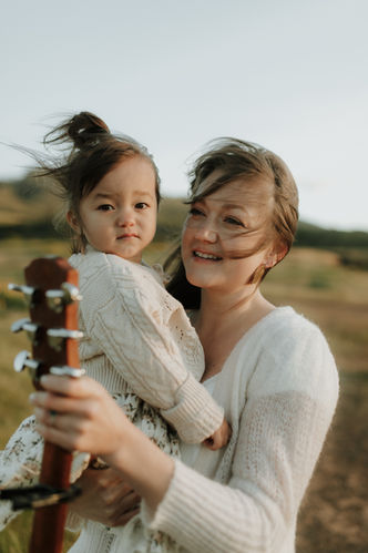 candid shot of mom and daughter during a family photo session near portland