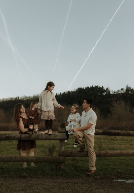 family climbs fence at sandy river delta in troutdale, oregon