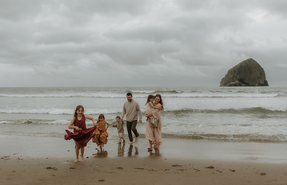 family runs on beach during a portland family photo session