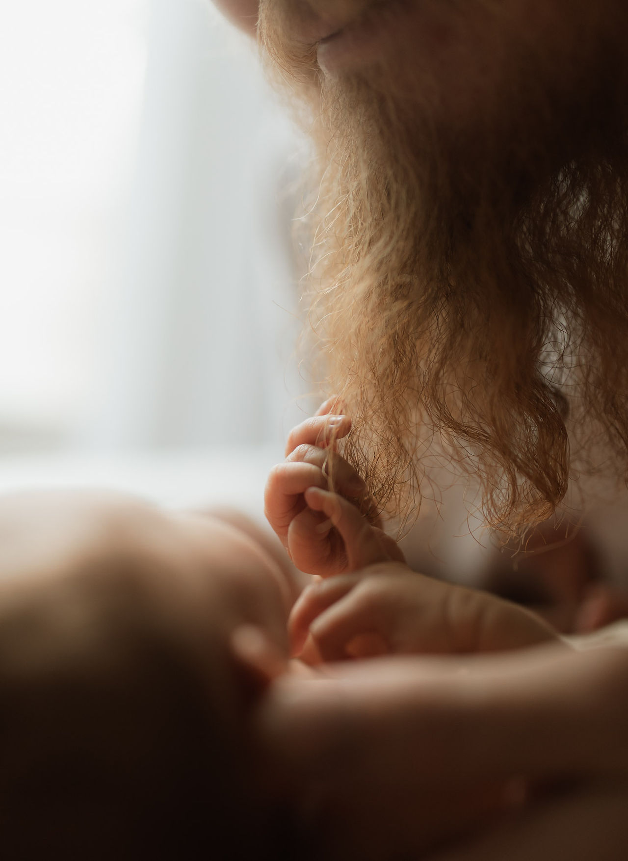 a newborn baby feels her dad's red beard