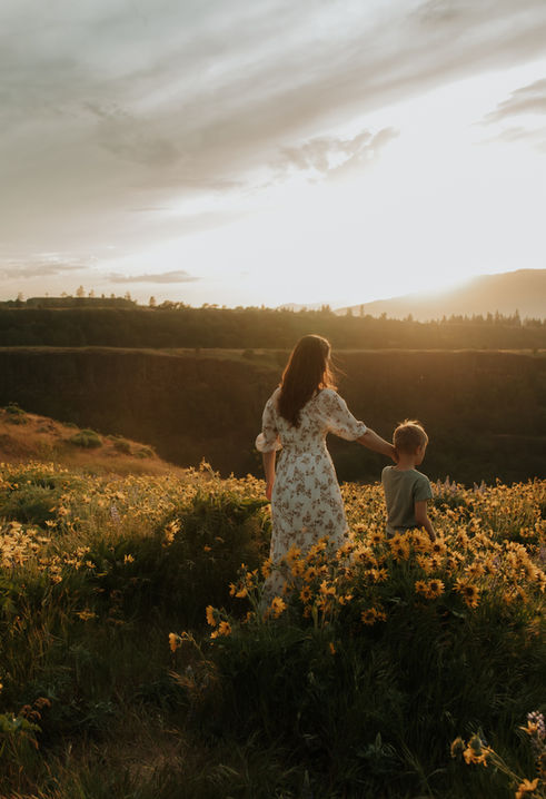 a mom and son walk through wildflowers in the Columbia River Gorge