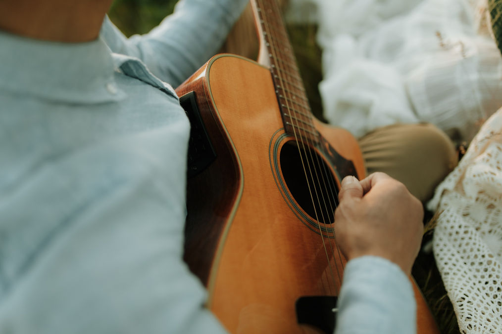 dad plays guitar during a family photography session near Portland, Oregon