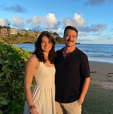 Founders of the company Rachael and Trevor smiling at camera with ocean behind