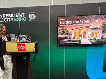 Laurie C. Fisher at the podium at the Resilient City Expo in Houston, next to her "Getting the Wood Out" presentation slide