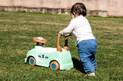 Baby first steps pushing toy car on grass outdoors.jpg