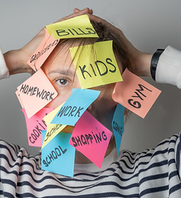 Mental load concept - female has post-it notes with social responcibilities on her face.jp