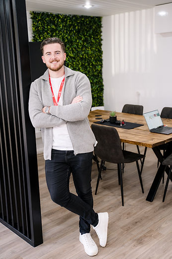 man leaning against pillar, arms crossed