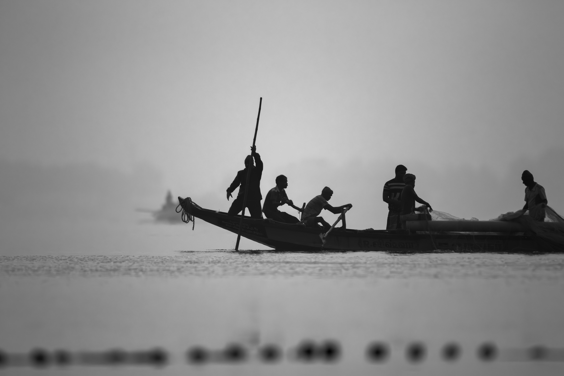 People in a boat on hazy water