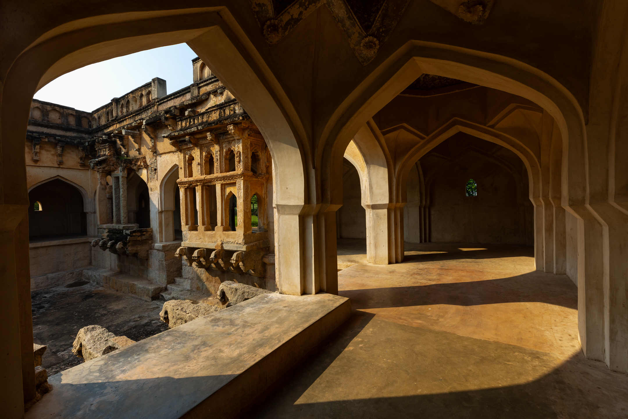 Ancient arched stone architecture in a sunlit courtyard