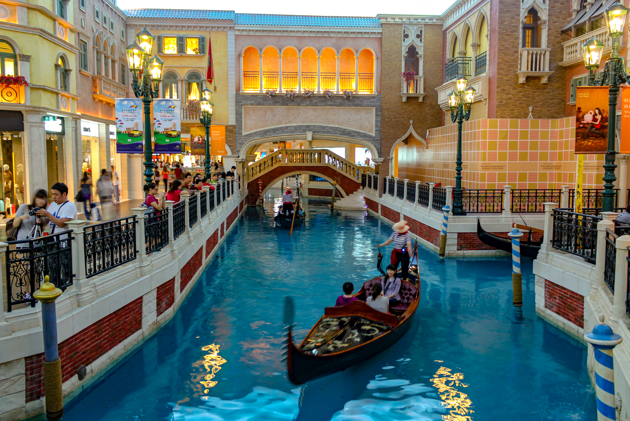 People travelling through an indoor canal setting