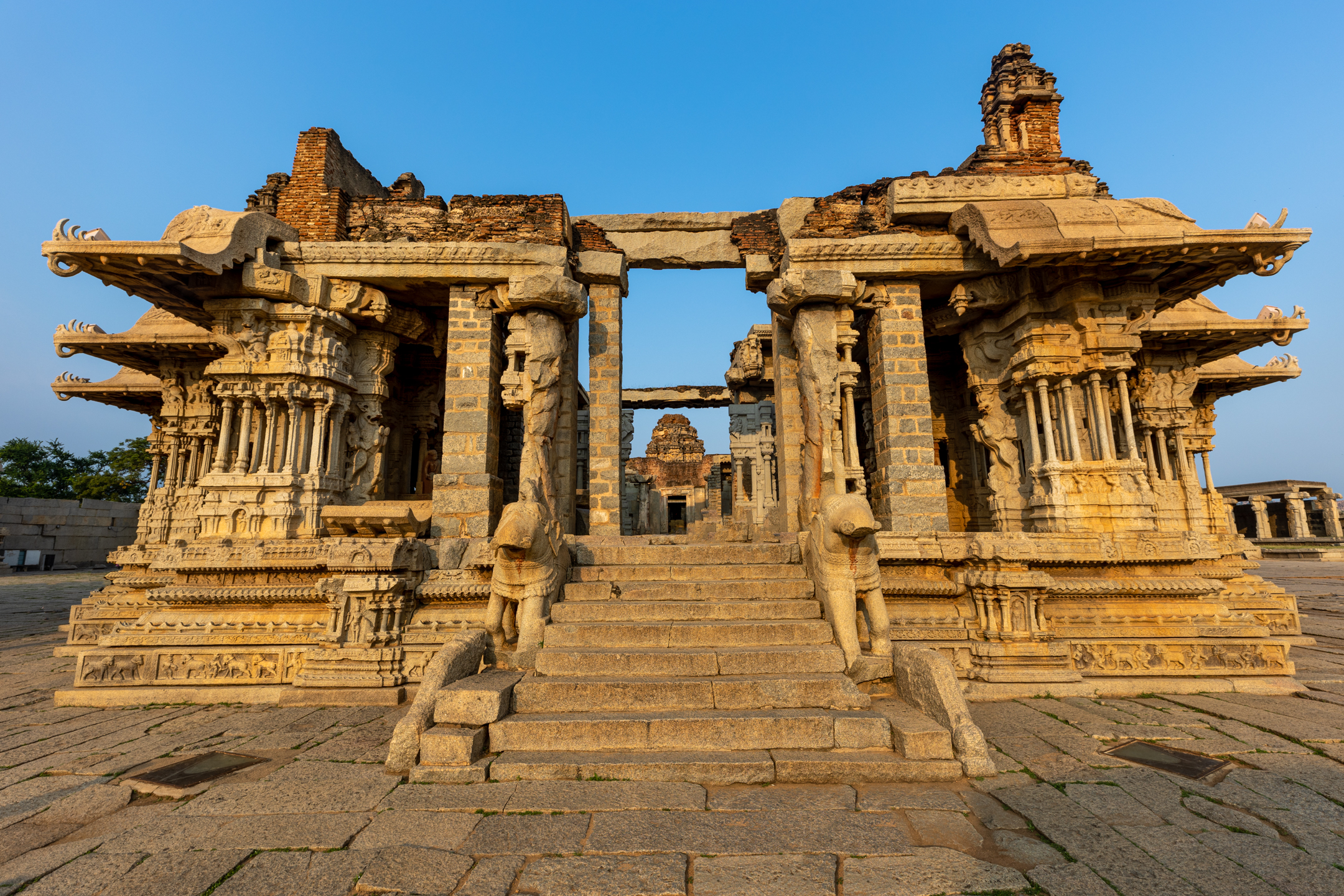 Close tonal study of carved stone pillars and shadow at Hampi