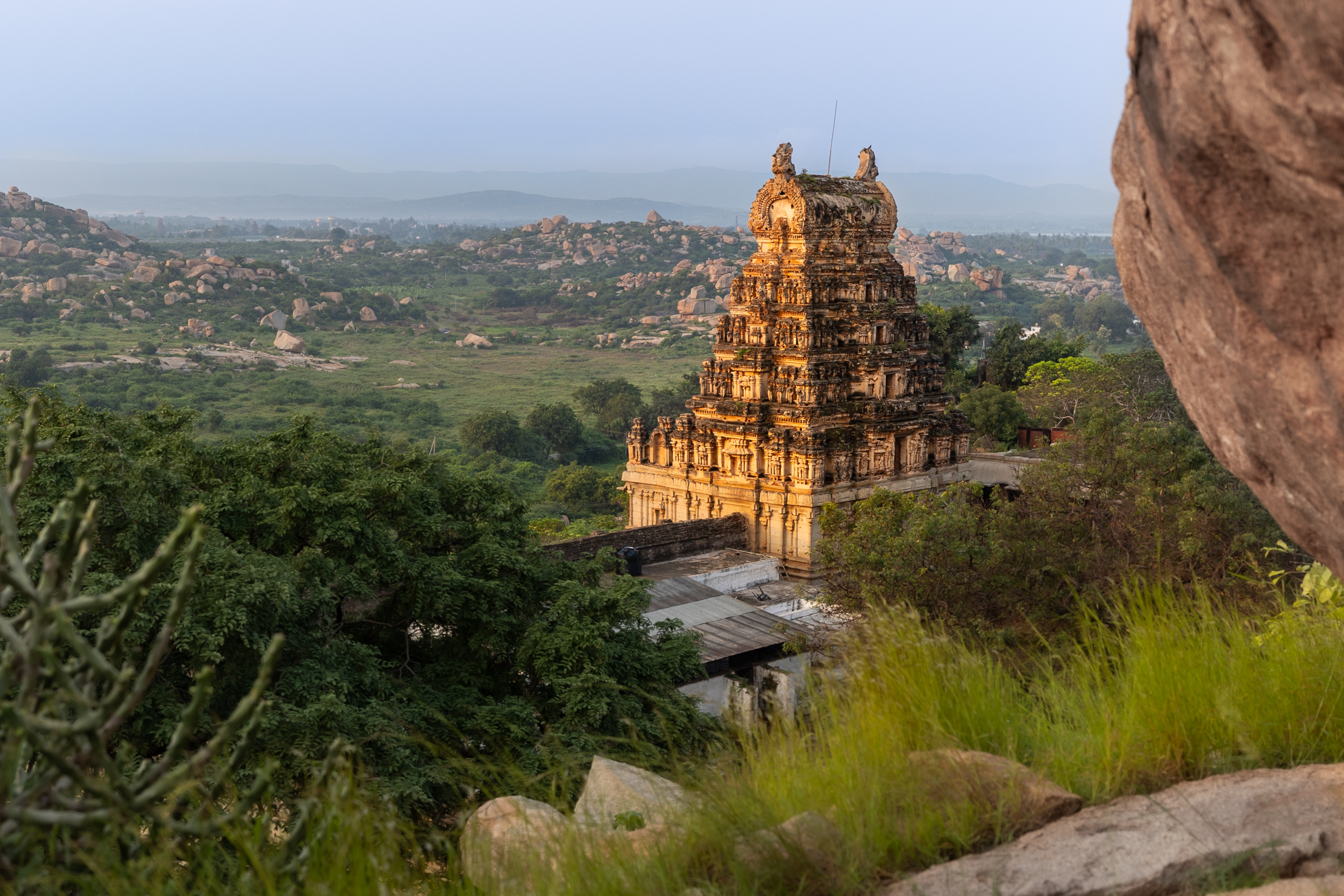 An ornate temple in a sprawling rocky landscape