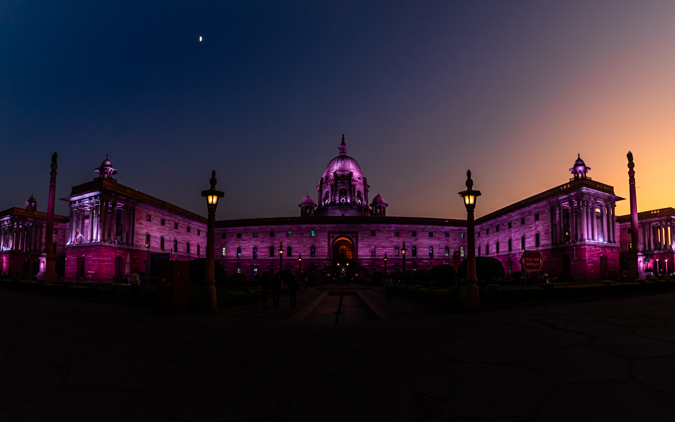 A regal building glowing under a violet twilight sky