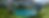 Turquoise alpine lake surrounded by dramatic mountain peaks and lush green valleys
