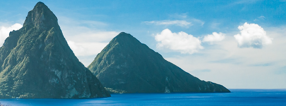 The iconic Pitons rising above the Caribbean Sea in Saint Lucia, a tropical destination known for luxury travel and all-inclusive resorts with breathtaking ocean views.
