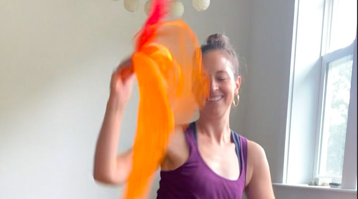 Woman dancing with brightly colored scarves