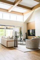 Minimalist living room with neutral tones, soft textures, and a mix of matte black and brass accents.