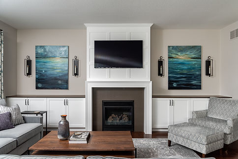 A modern living room with a fire place, designed by Melissa Walsh Interiors, Niagara interior designer