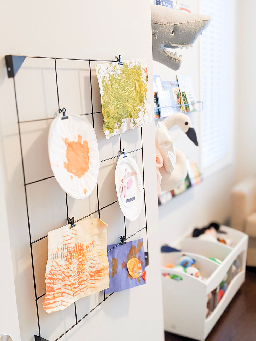 Kid's art hanging on a wall in a kid's room designed by Vanessa Silva, Be In Wonder Designs