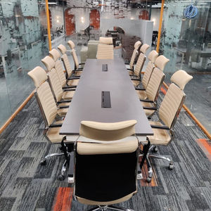 Modern conference room with long table and chairs.