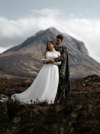 Bride and groom together beneath the Cuillin Mountains