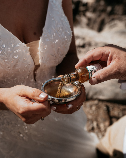 Quaich filled with whisky during a Highland wedding ceremony