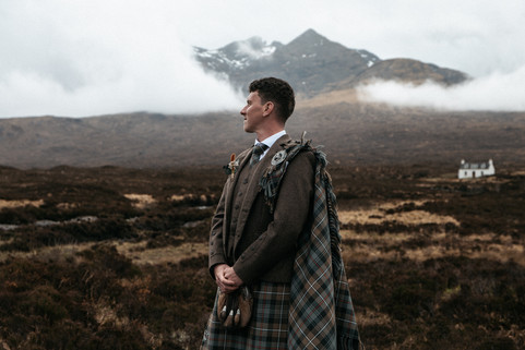 Groom portrait beneath the Cuillin Mountains before the wedding ceremony