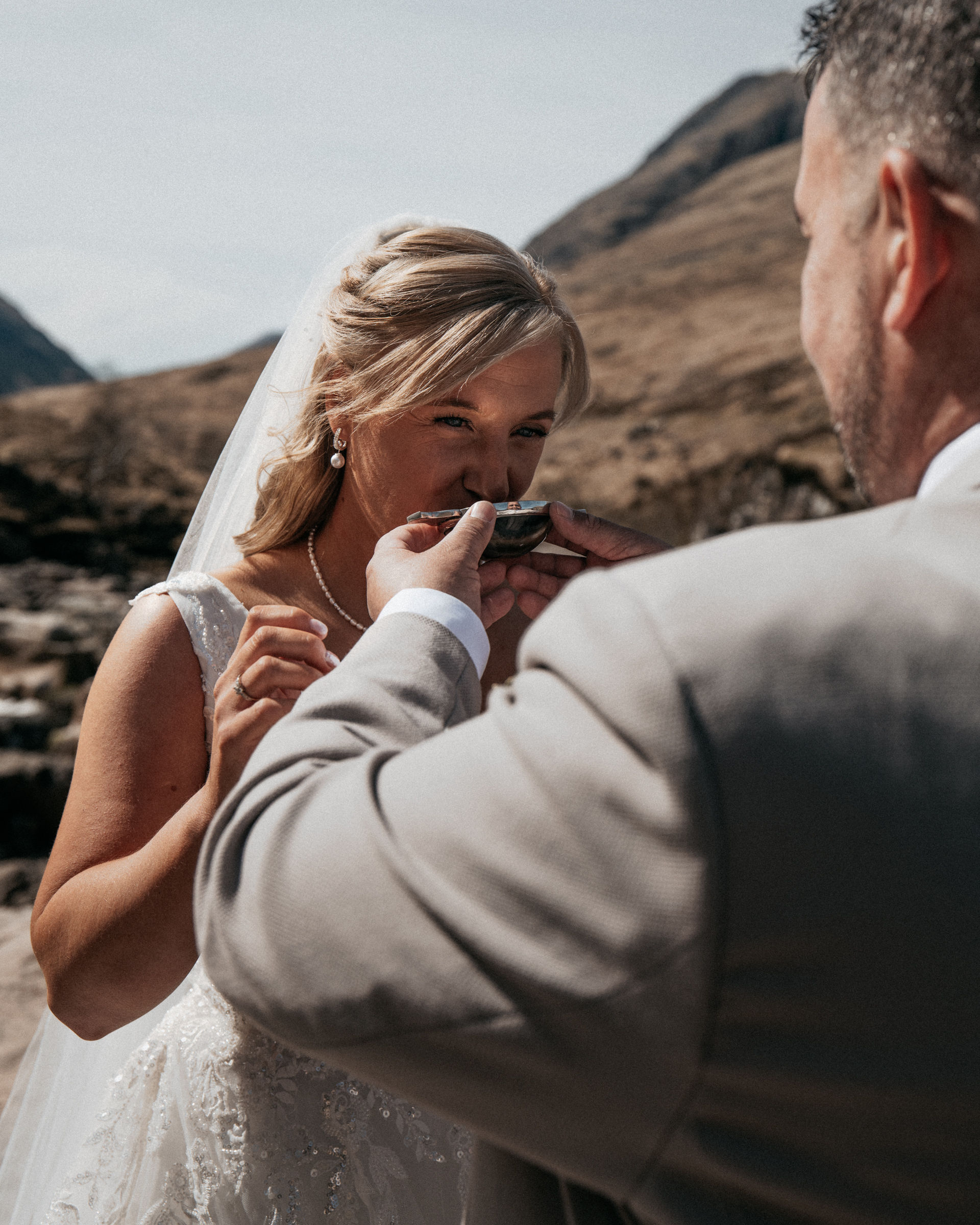Laura and Gary sharing whisky from a quaich during their ceremony