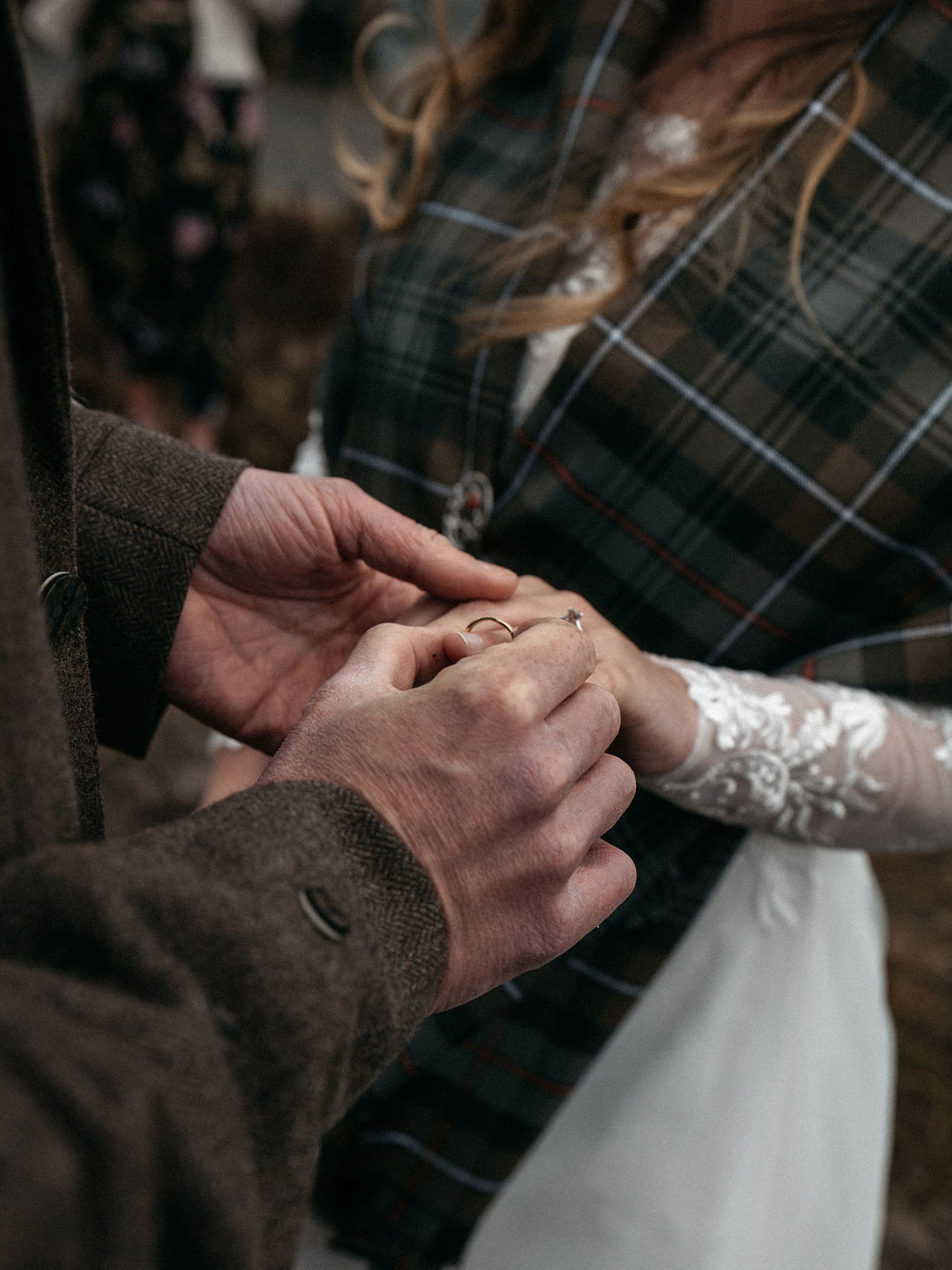 Groom placing ring on brides finger during Skye wedding ceremony