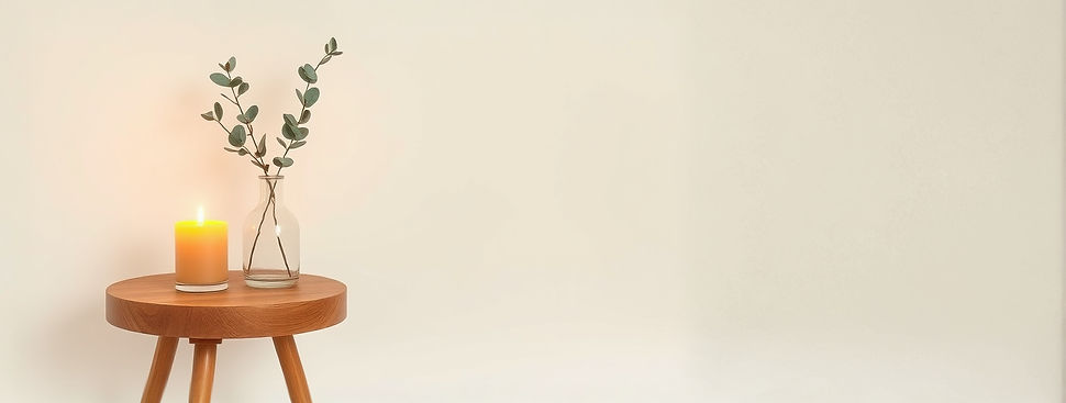 light beige off white_nude color background, small round wood table on the left of the pho