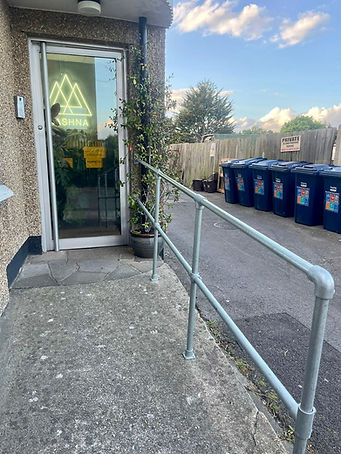 A photo o Aashna's step entrance step free access ramp with handrail.