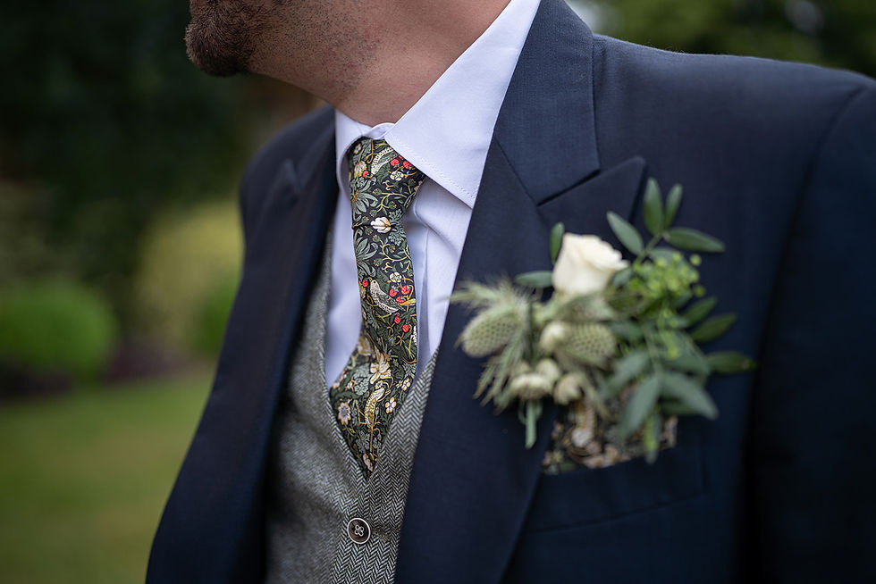 Navy tails styled with floral tie and tweed waistcoat